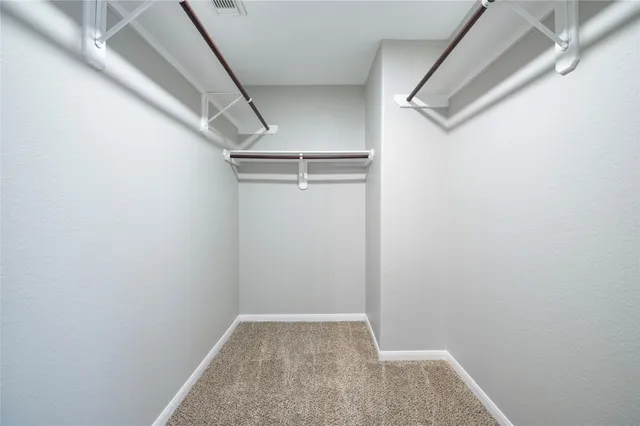 a bathroom with a granite countertop sink mirror vanity toilet and bathtub