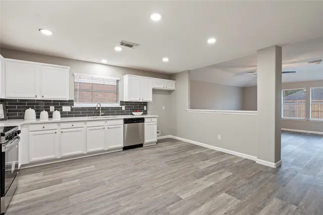 a living room with furniture a rug and a flat screen tv