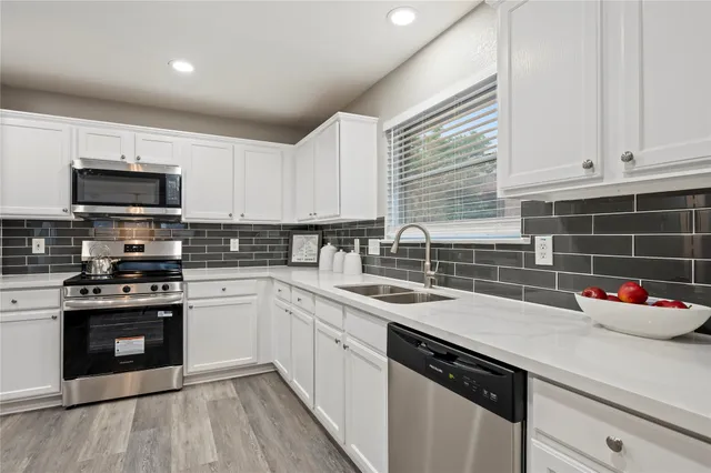 an empty room with a window and ceiling fan