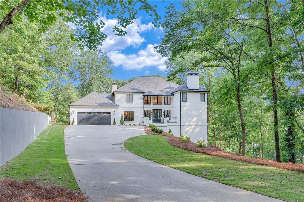 2929 Thompson Mill Road Gainesville, GA 30506 - Photo 1 of 1 a front view of a house with a garden and trees