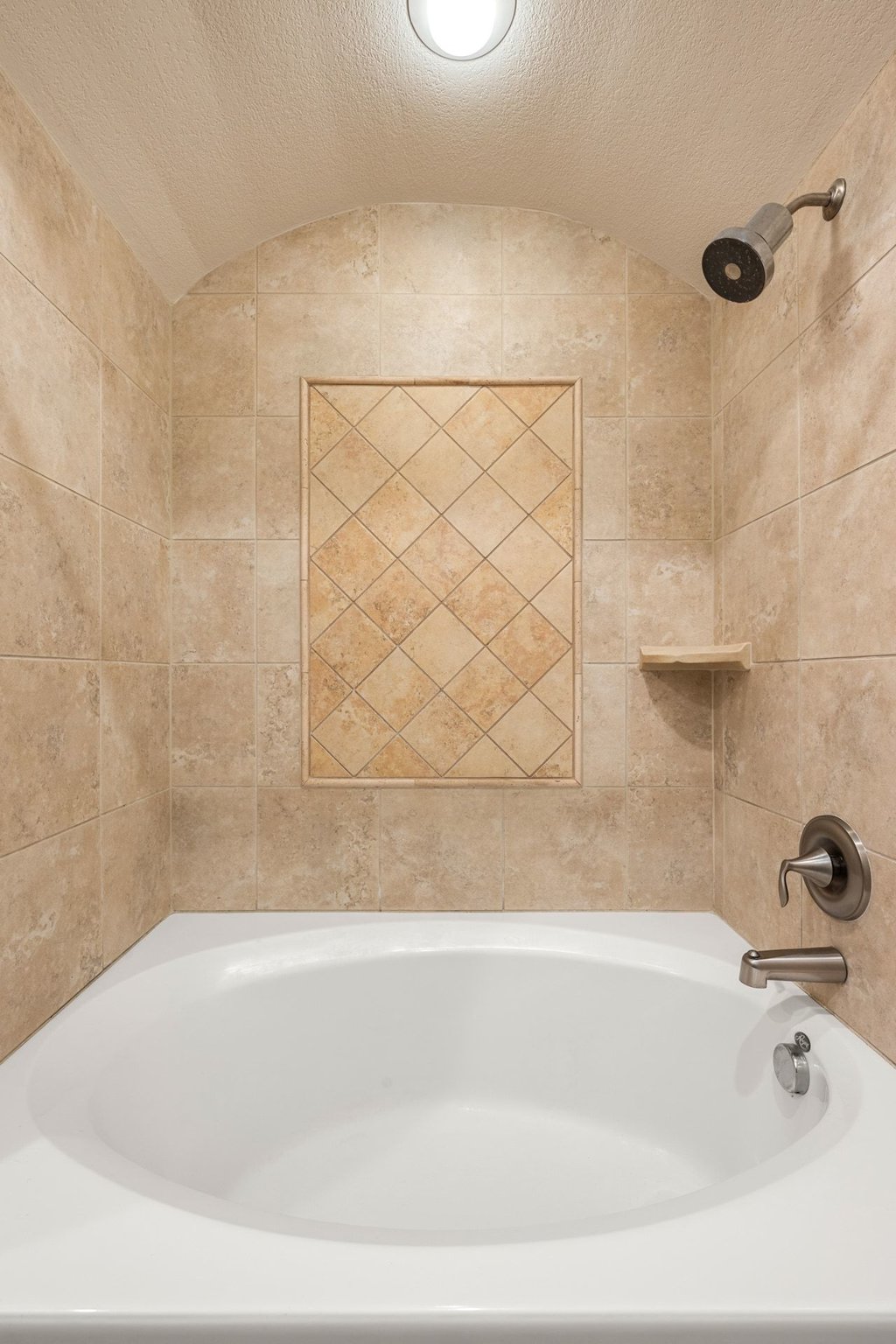 6708 Menchaca Road, Unit 2 Austin, TX 78745 - Photo 24 of 30 Built-in bathtub with neutral-toned tile surround