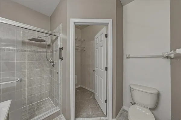 a bathroom with a toilet and a shower
