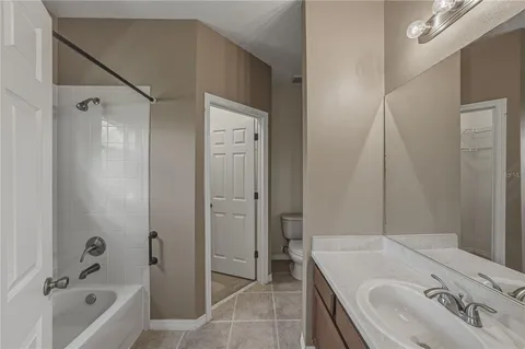 a bathroom with a tub sink and mirror