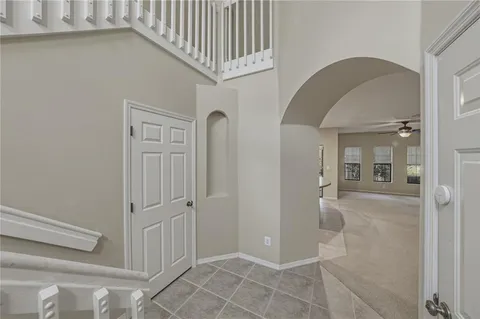 a view of a hallway with wooden floor and entryway