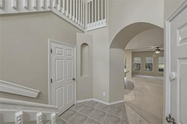 a view of a hallway with wooden floor and entryway