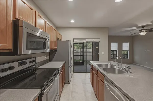 a kitchen with stainless steel appliances granite countertop a sink and a stove