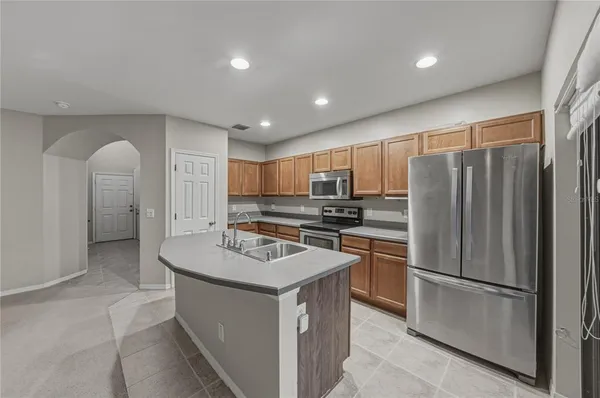a kitchen with refrigerator cabinets and furniture