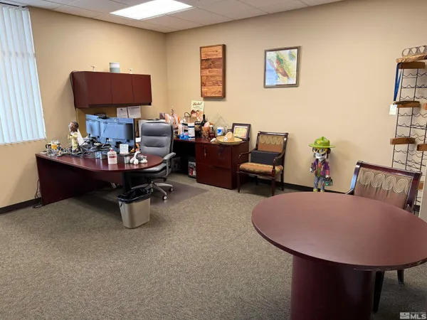 a living room with furniture and a mirror