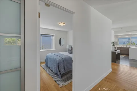 a bedroom with a bed and a large window