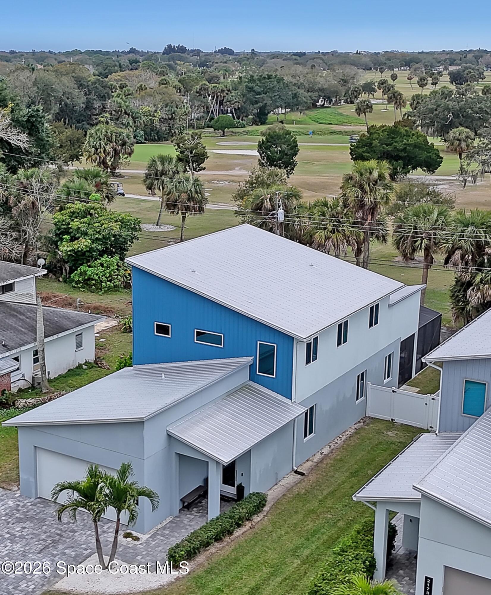 an aerial view of a house with a yard