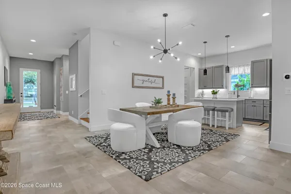 a living room with furniture a clock and white walls