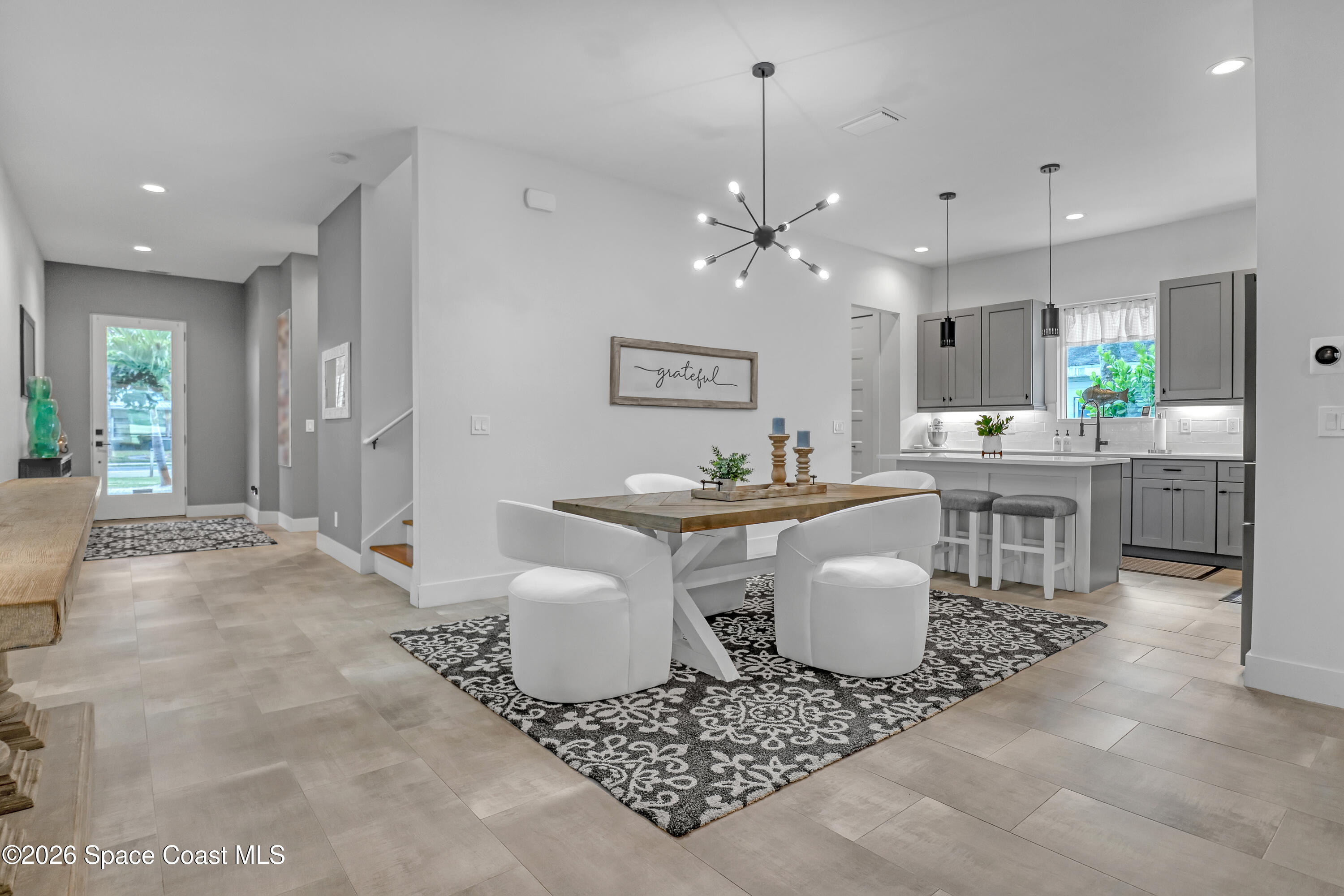 2188 Country Club Road Melbourne, FL 32901 - Photo 14 of 51 a living room with patio furniture and a chandelier