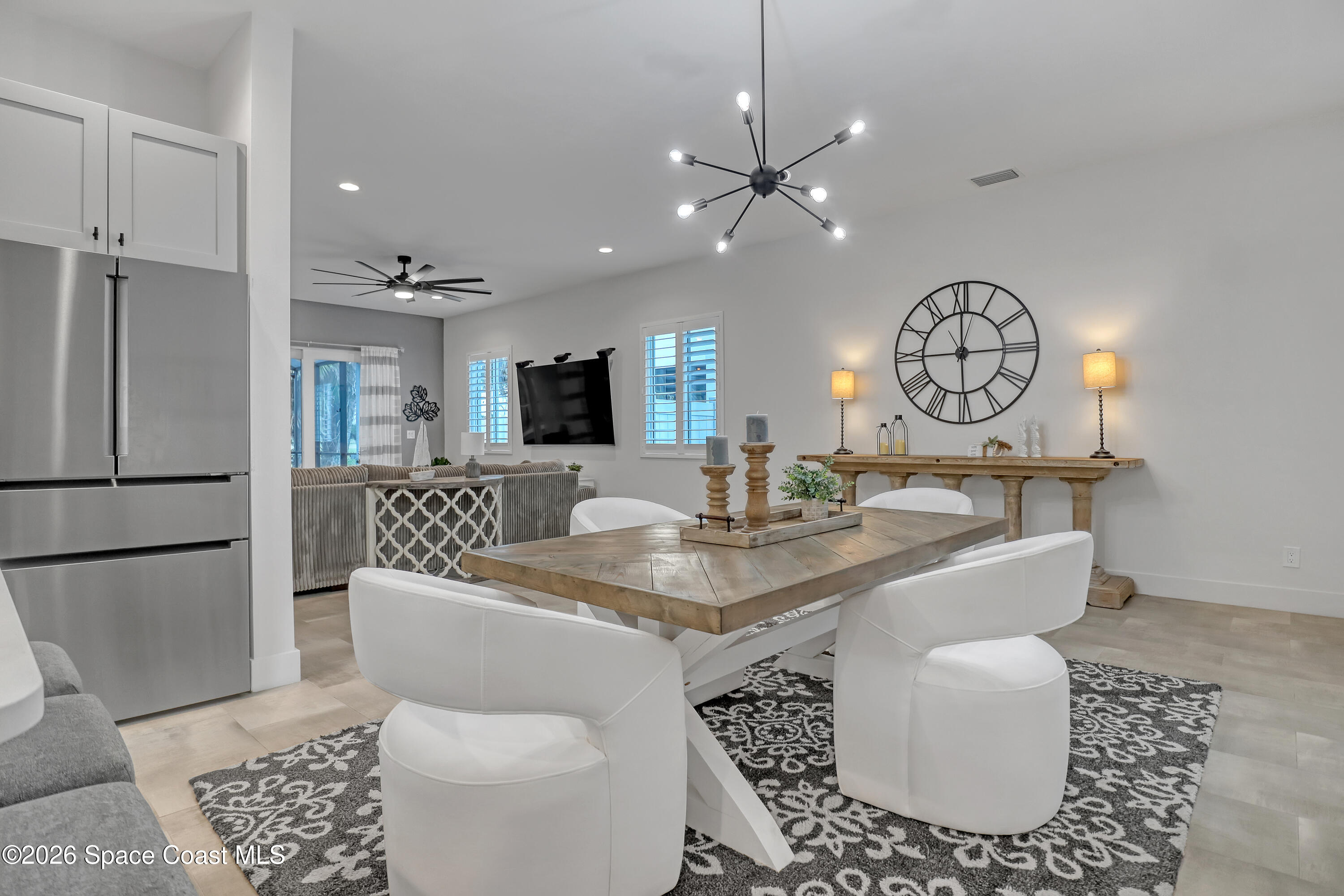 2188 Country Club Road Melbourne, FL 32901 - Photo 15 of 51 a living room with furniture a clock and white walls