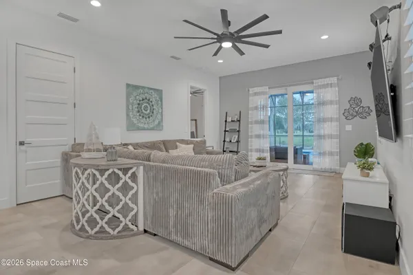 a living room with furniture and a flat screen tv