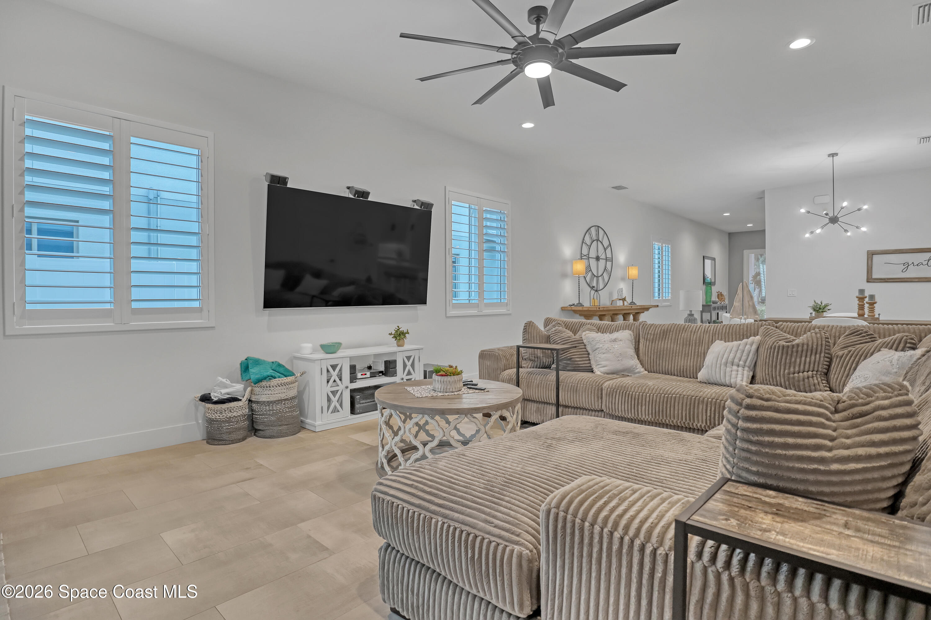 2188 Country Club Road Melbourne, FL 32901 - Photo 18 of 51 a living room with furniture and a flat screen tv