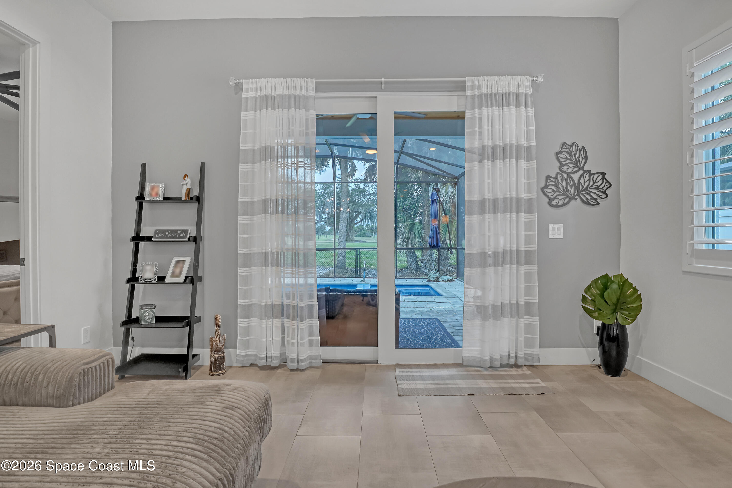 2188 Country Club Road Melbourne, FL 32901 - Photo 19 of 51 a bedroom with furniture and a window