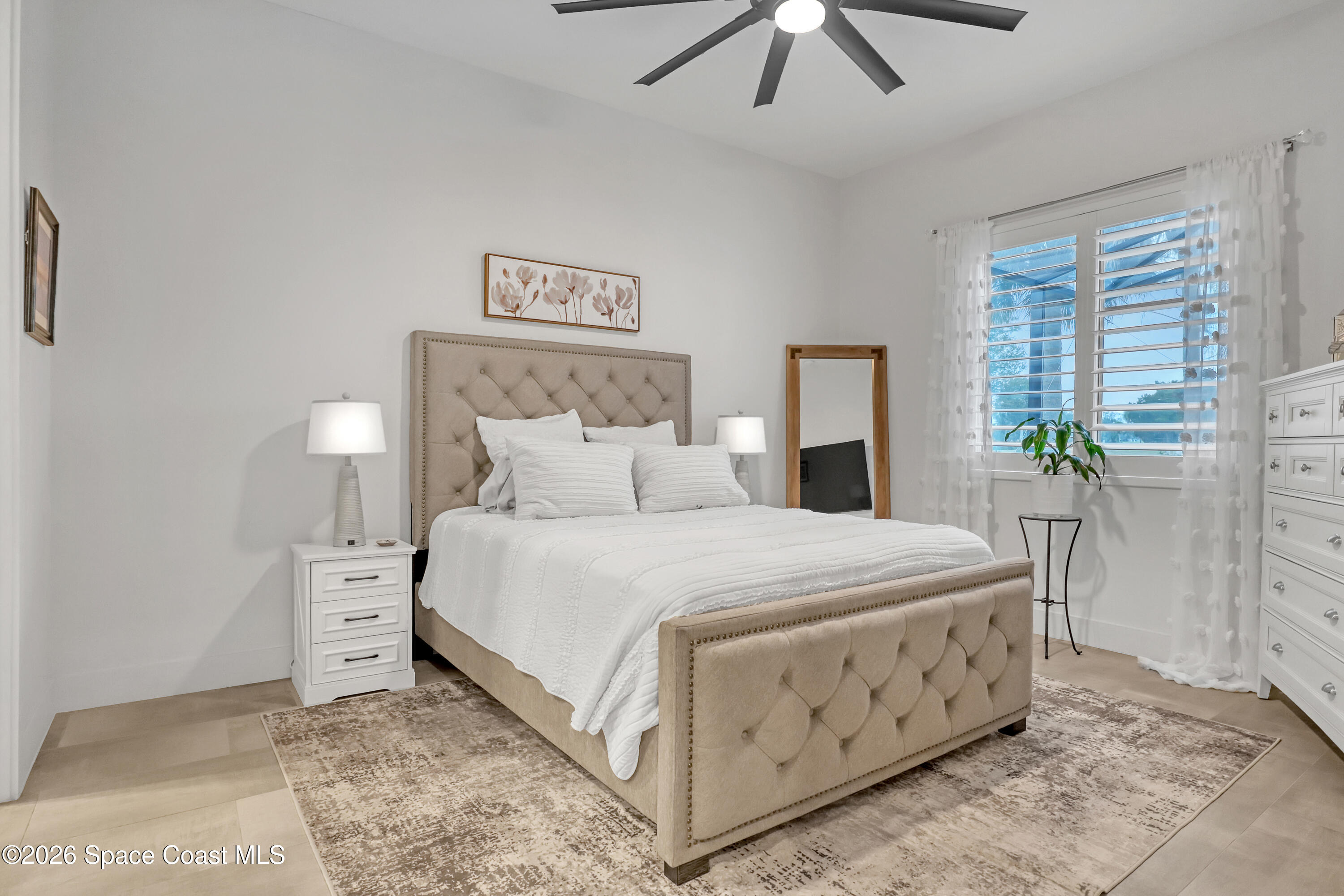 2188 Country Club Road Melbourne, FL 32901 - Photo 20 of 51 a bedroom with a bed and a chandelier