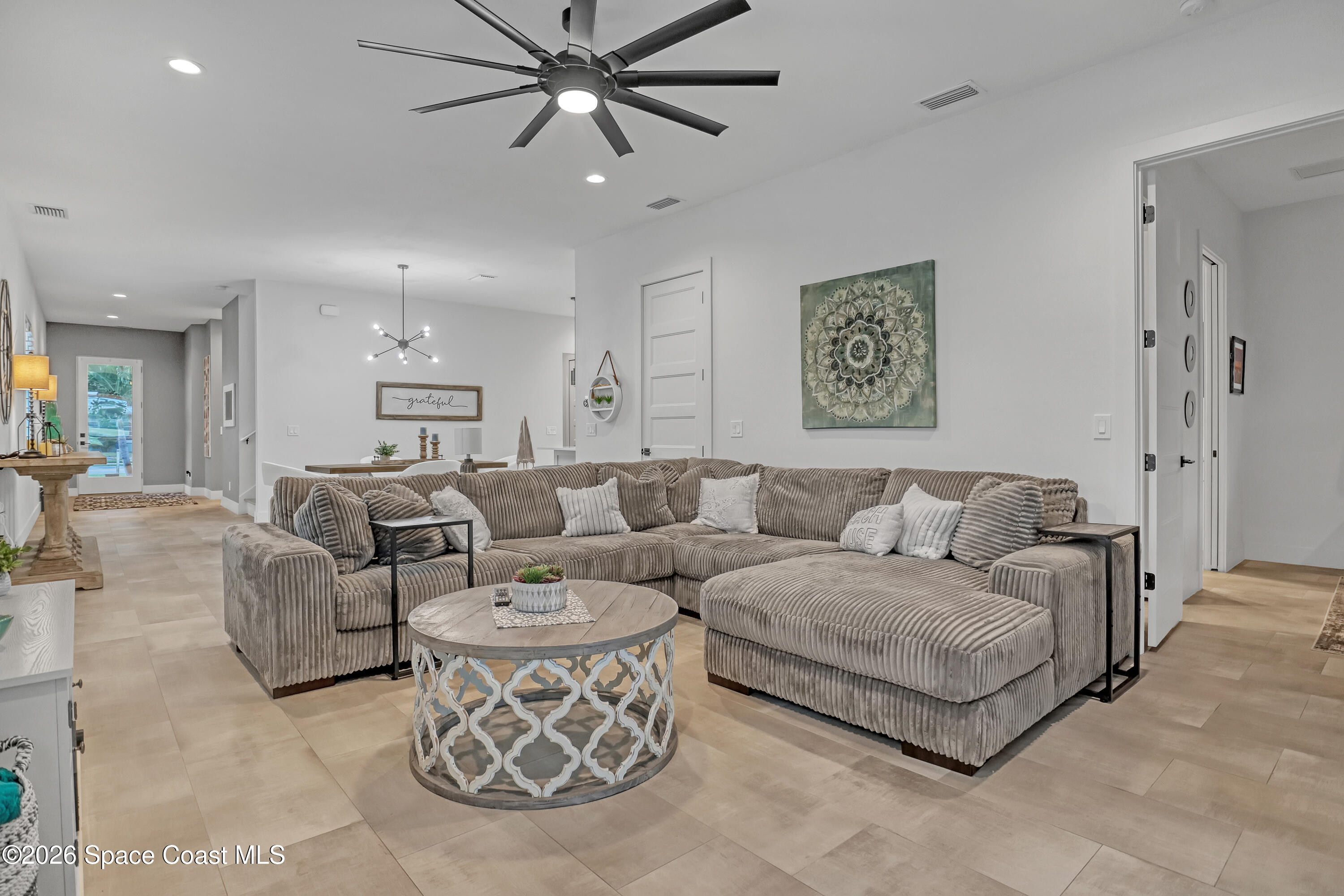 2188 Country Club Road Melbourne, FL 32901 - Photo 20 of 57 a living room with furniture and a chandelier
