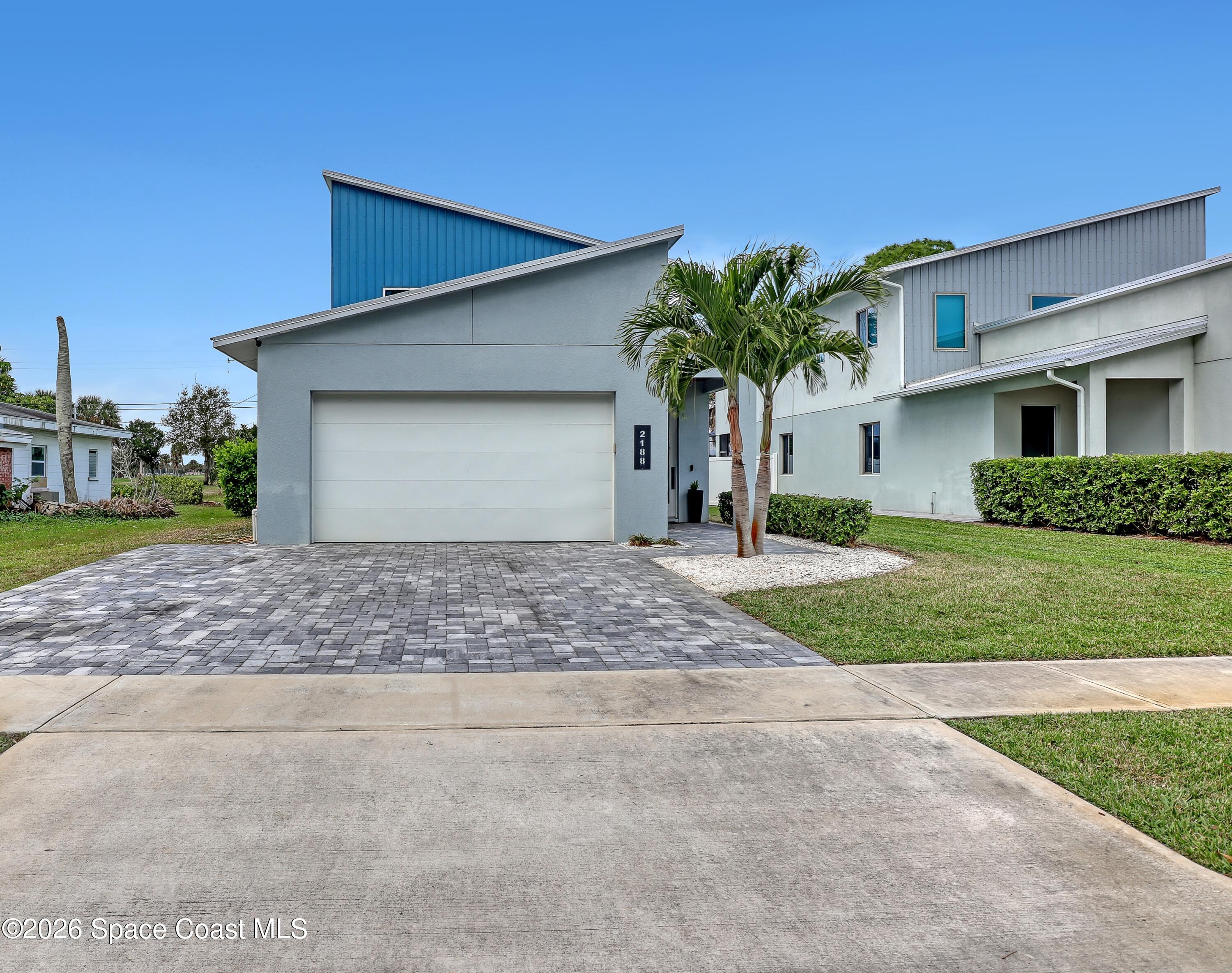 2188 Country Club Road Melbourne, FL 32901 - Photo 2 of 51 a front view of a house with garden