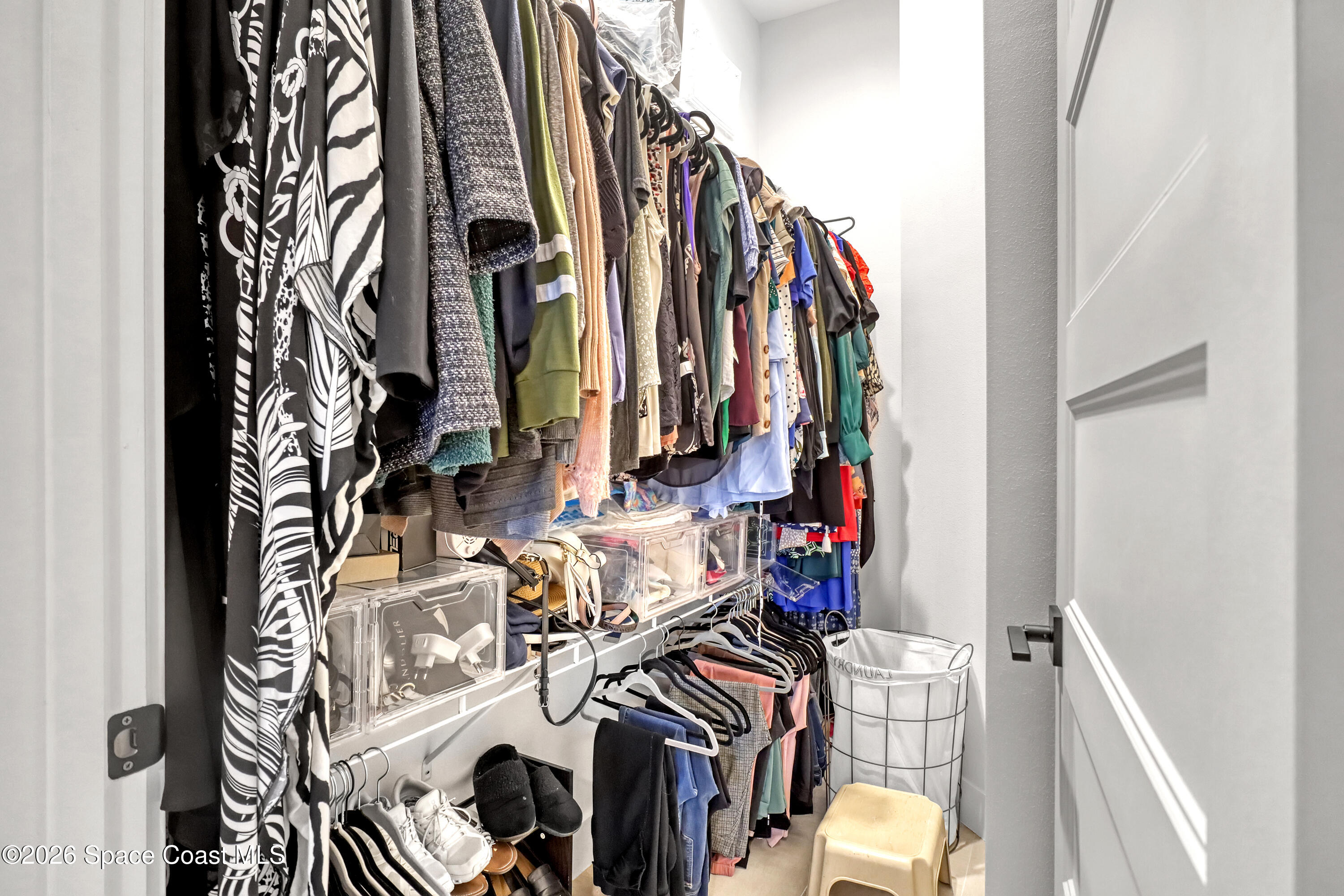 2188 Country Club Road Melbourne, FL 32901 - Photo 24 of 51 a view of walk in closet with clothes and shoes