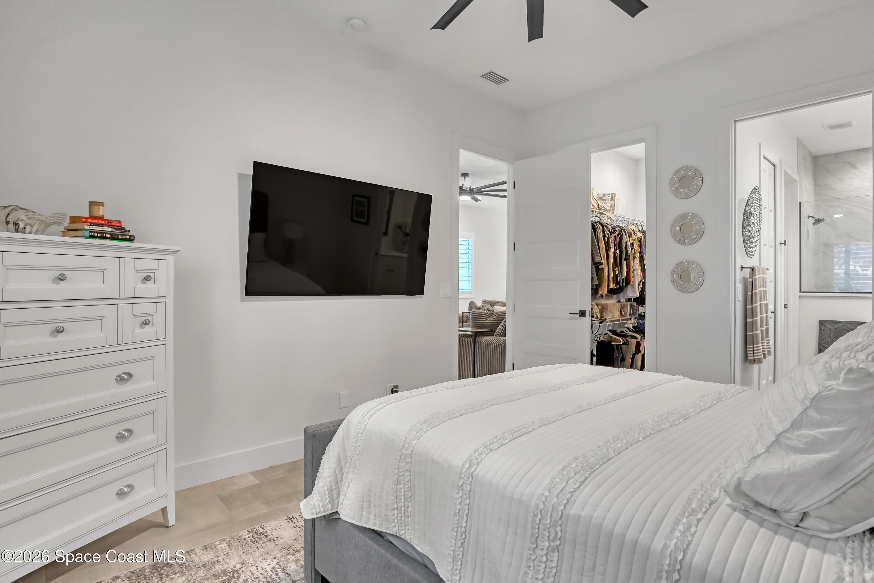 2188 Country Club Road Melbourne, FL 32901 - Photo 25 of 57 a bedroom with a bed and a flat screen tv