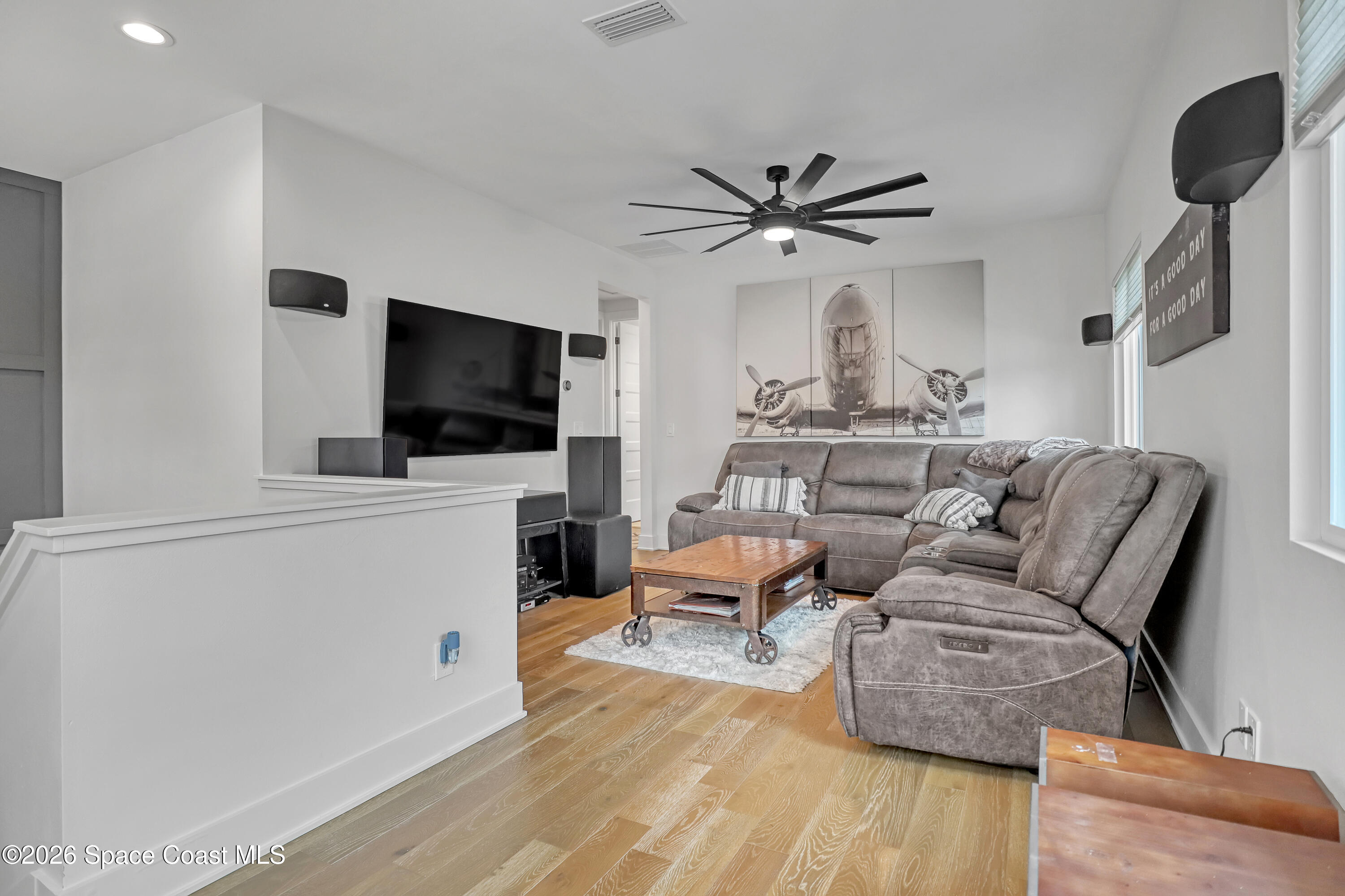 2188 Country Club Road Melbourne, FL 32901 - Photo 27 of 51 a living room with furniture a flat screen tv and kitchen view