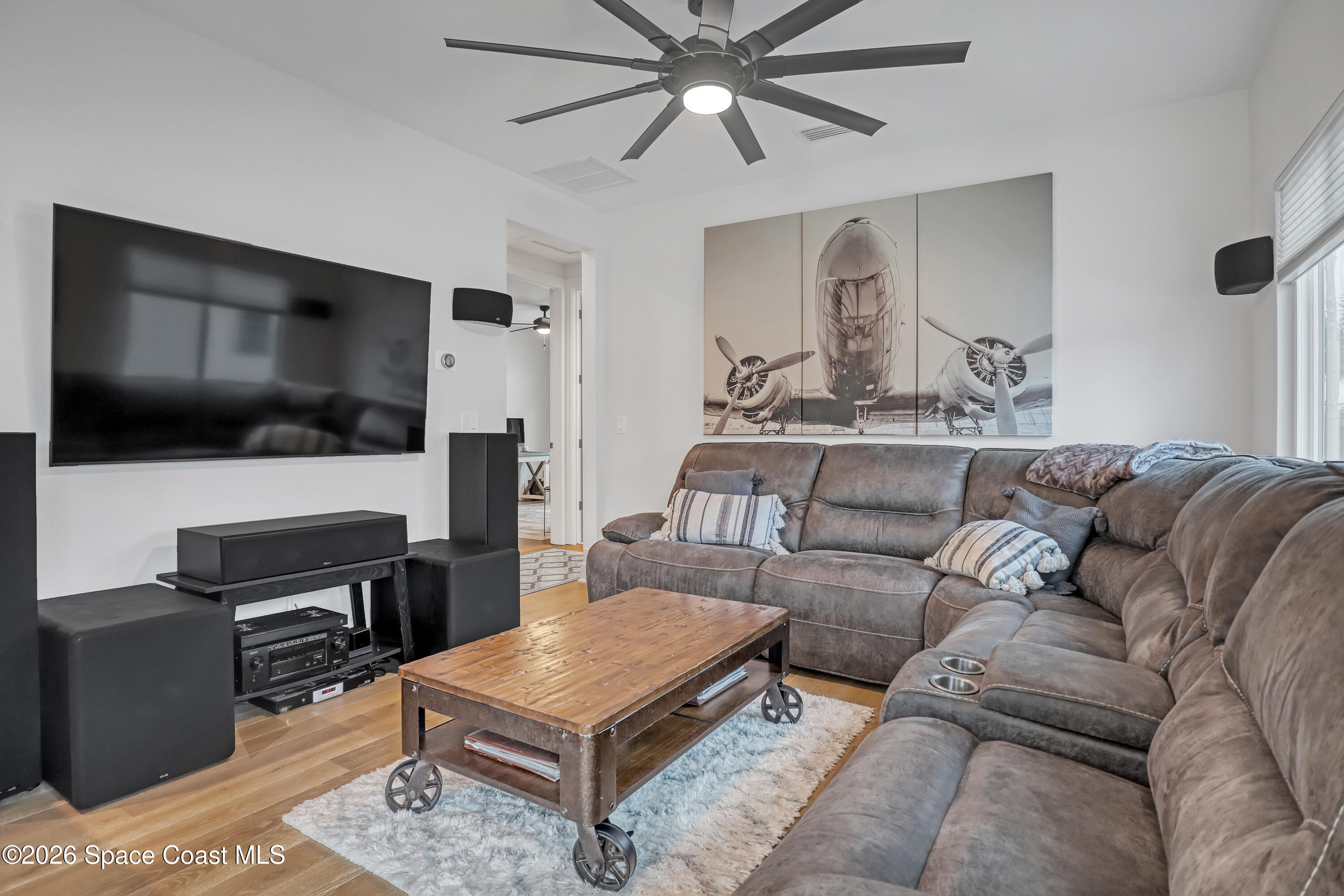2188 Country Club Road Melbourne, FL 32901 - Photo 29 of 51 a living room with furniture and a flat screen tv