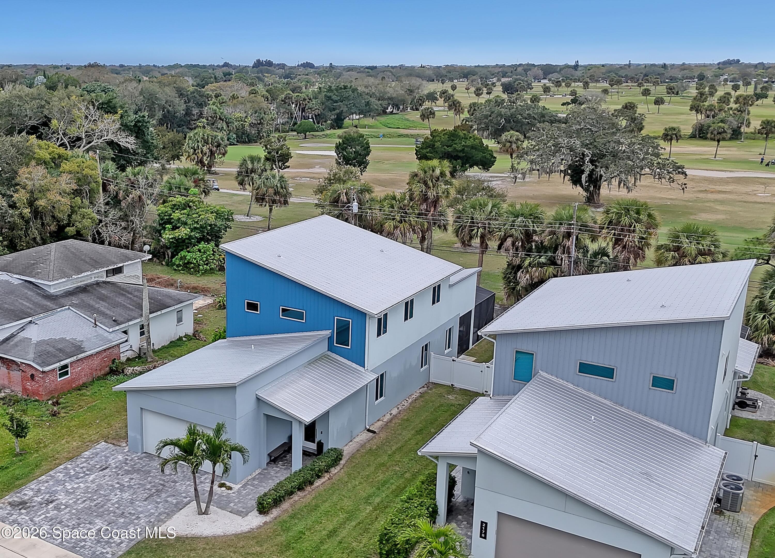 2188 Country Club Road Melbourne, FL 32901 - Photo 3 of 57 an aerial view of a house with a yard