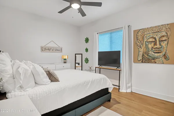 a bedroom with a bed and a night stand