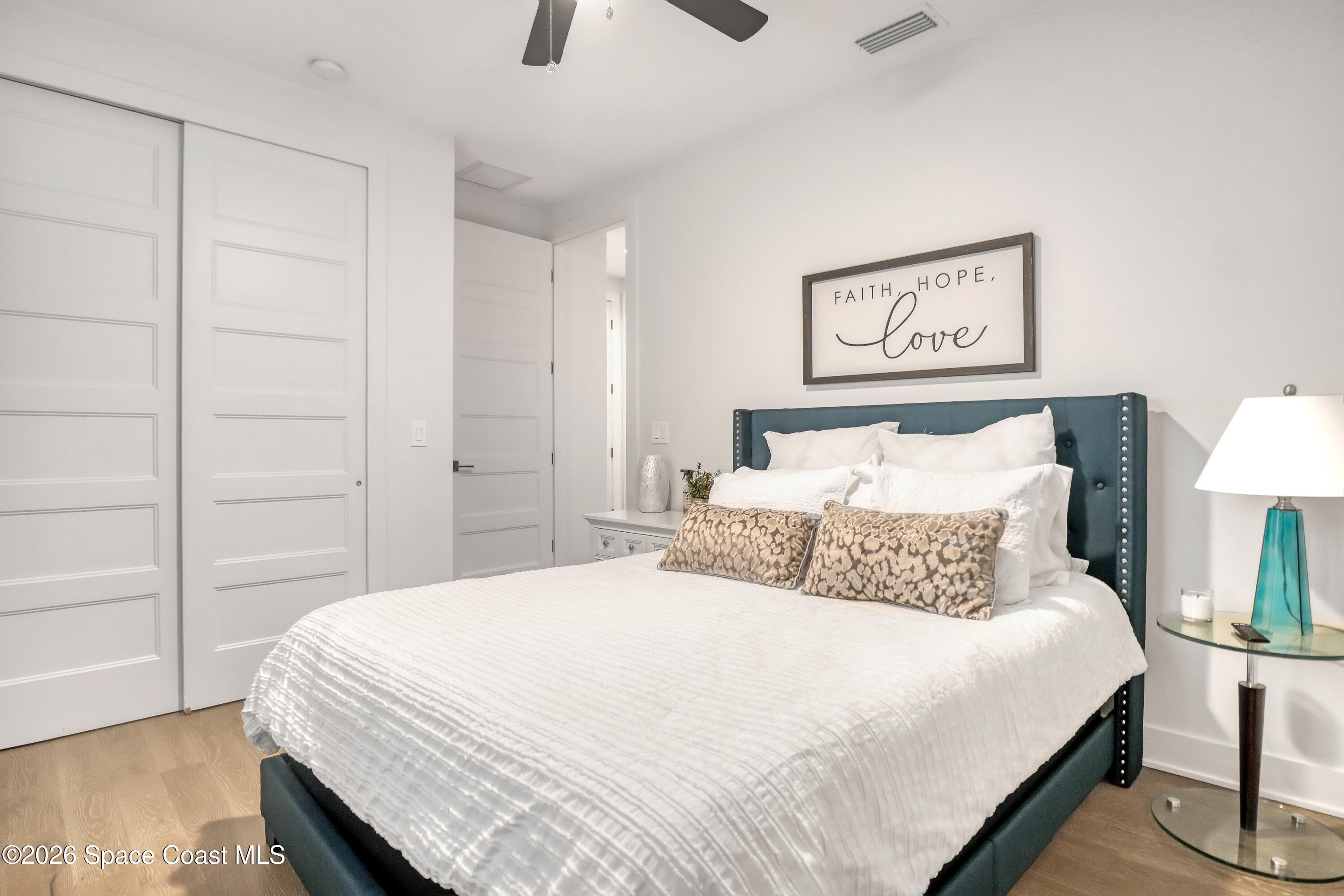 2188 Country Club Road Melbourne, FL 32901 - Photo 35 of 51 a bedroom with a bed and a night stand