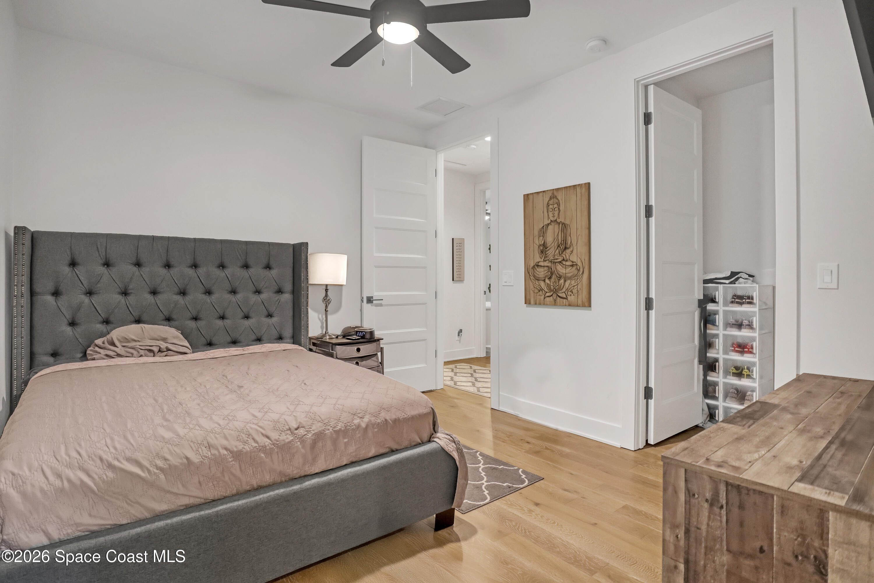 2188 Country Club Road Melbourne, FL 32901 - Photo 36 of 57 a bedroom with a bed and a chandelier