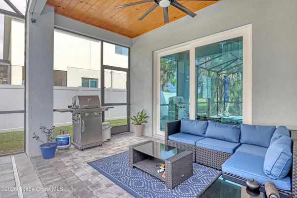 a view of a living room with a floor to ceiling window next to a yard