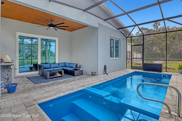 a swimming pool with an outdoor seating