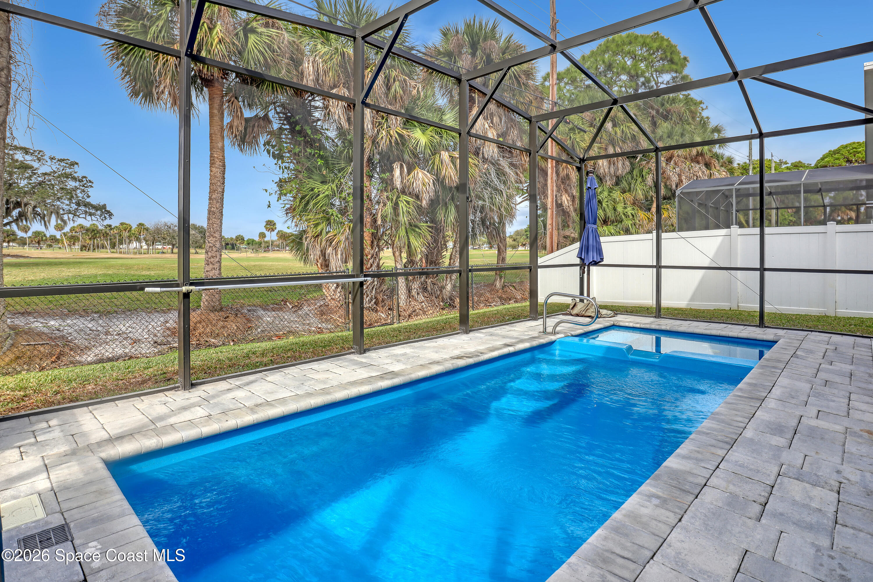 2188 Country Club Road Melbourne, FL 32901 - Photo 49 of 57 a view of a swimming pool with a porch