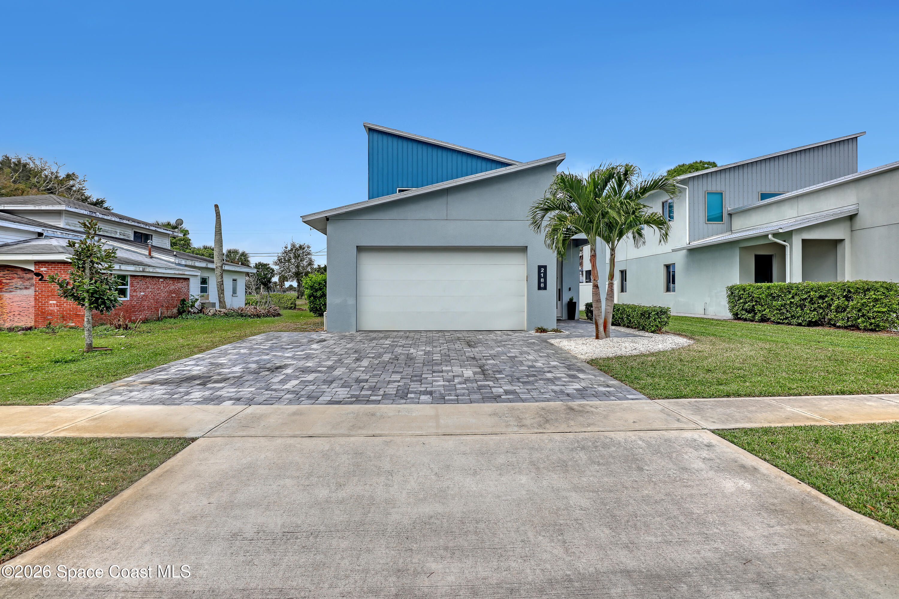 2188 Country Club Road Melbourne, FL 32901 - Photo 7 of 57 a front view of a house with a yard and garage