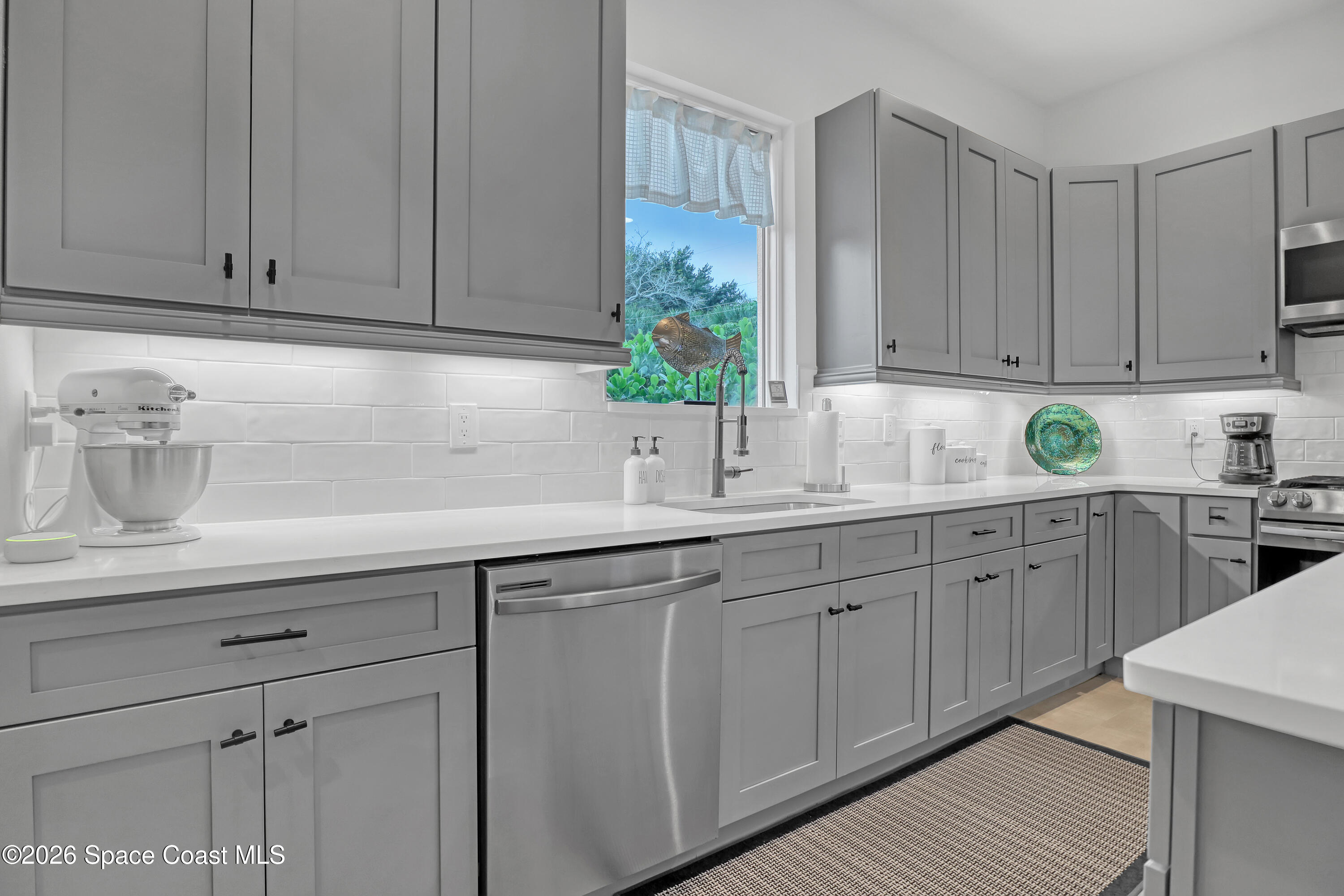 2188 Country Club Road Melbourne, FL 32901 - Photo 9 of 51 a kitchen with stainless steel appliances granite countertop white cabinets sink and dishwasher