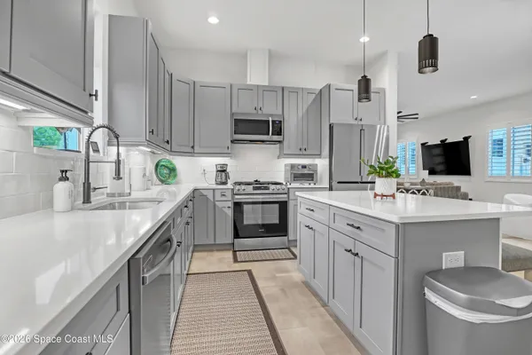 a kitchen with a sink stove and microwave