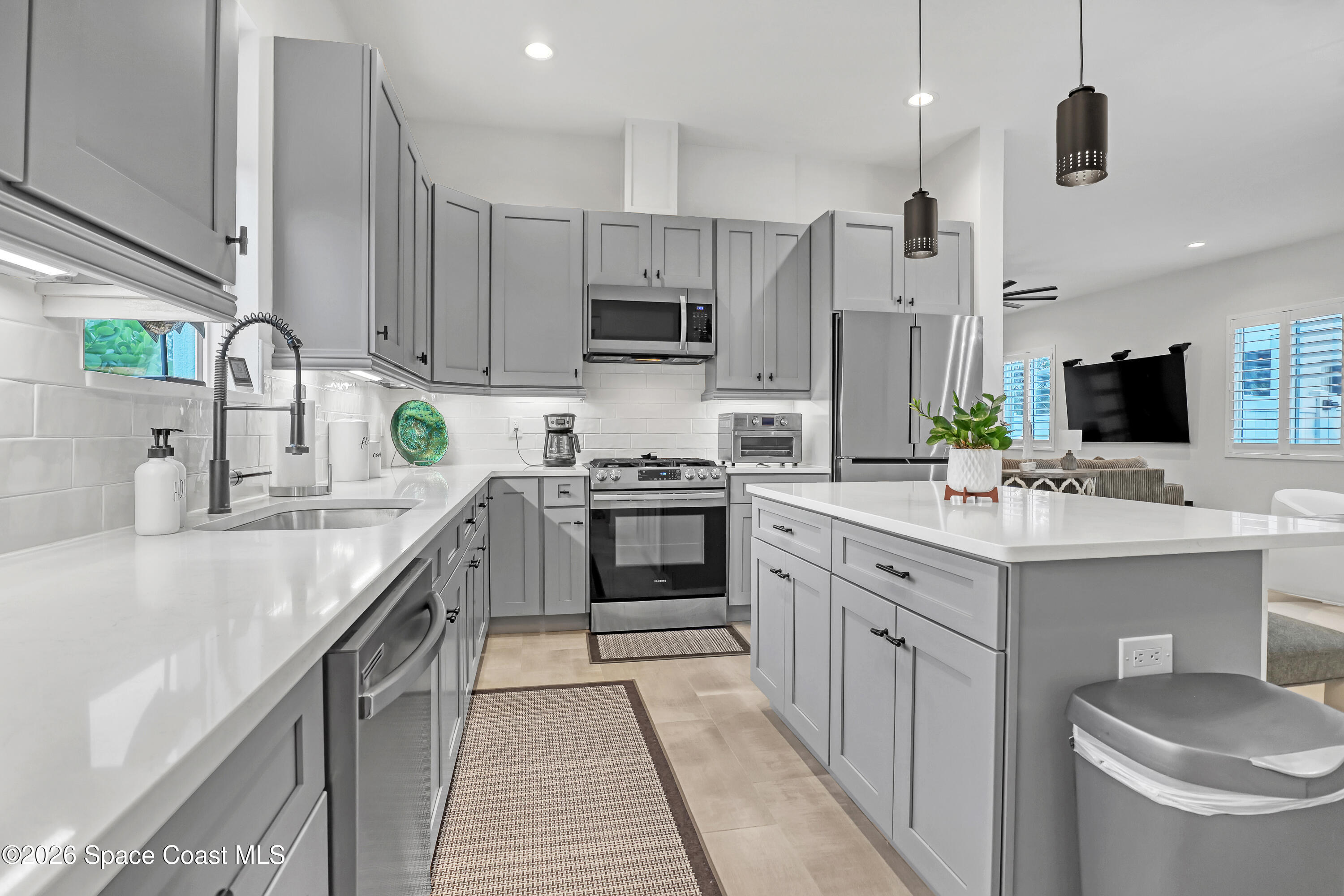 2188 Country Club Road Melbourne, FL 32901 - Photo 10 of 51 a kitchen with a sink stove and microwave