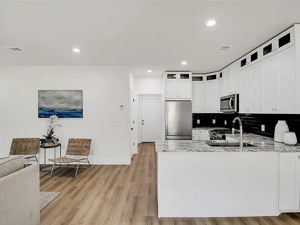a view of a dining room with furniture and wooden floor