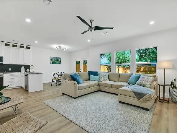 a view of a kitchen with kitchen island a sink and a large window