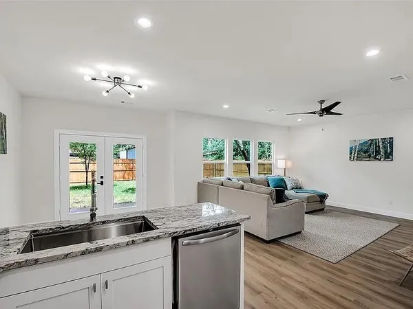 a living room with furniture and kitchen view