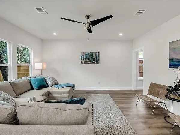 a living room with furniture and kitchen view