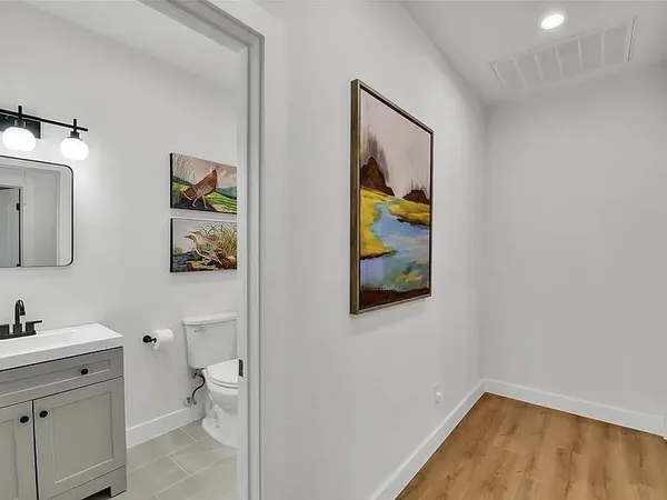 a bathroom with a toilet a sink and mirror