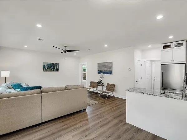 a kitchen with granite countertop white cabinets and white appliances
