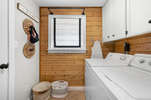 a kitchen with stainless steel appliances granite countertop a stove a sink a refrigerator and white cabinets with wooden floor