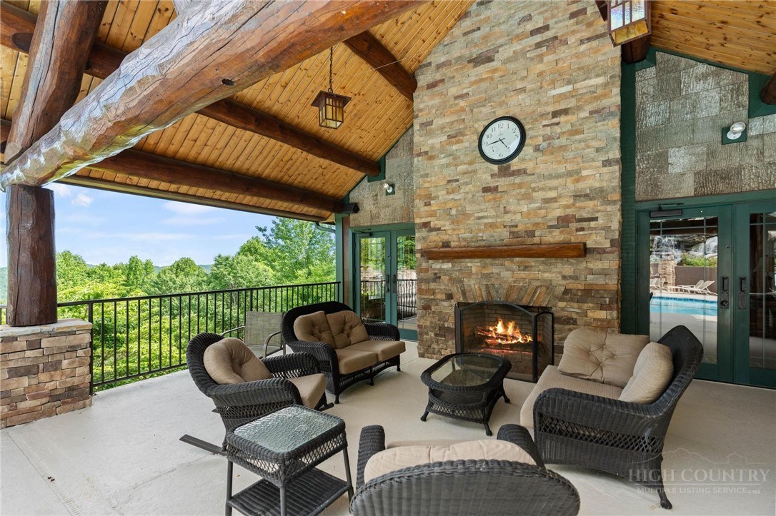 142 Evening View Lane, Unit CA3 Boone, NC 28607 - Photo 36 of 41 a view of a patio with couches chairs and a fireplace