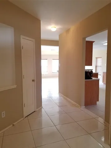 a view of a kitchen with a sink and a refrigerator