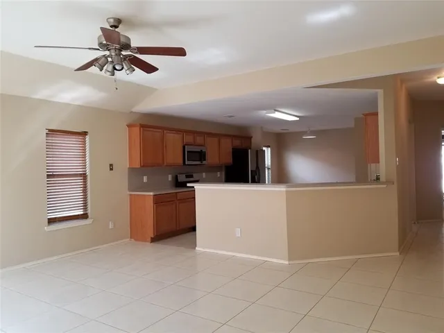a view of a kitchen with microwave and cabinets