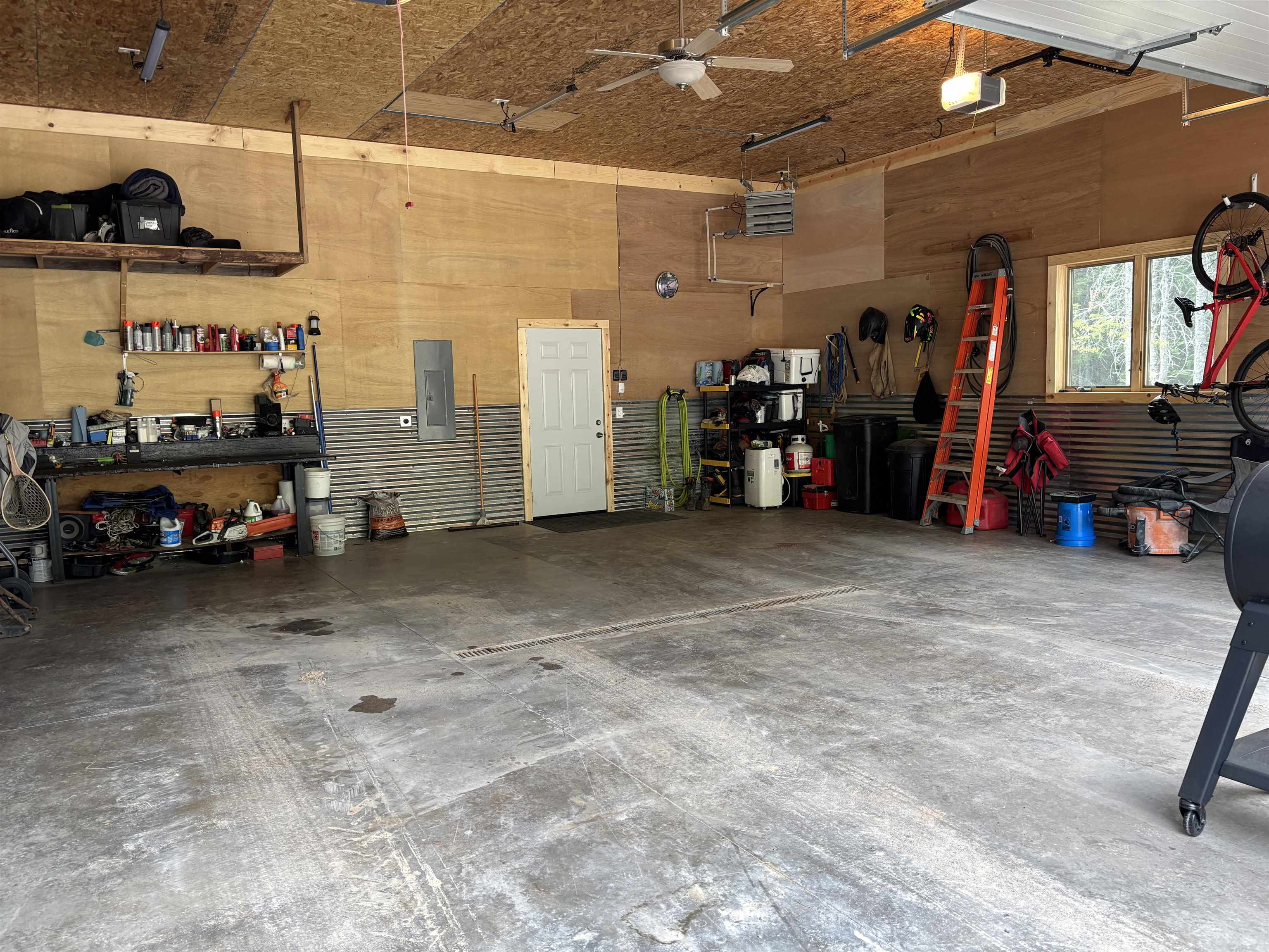 7238 Morris Thomas Road Cloquet, MN 55720 - Photo 20 of 27 Garage with a workshop area, electric panel, and a garage door opener