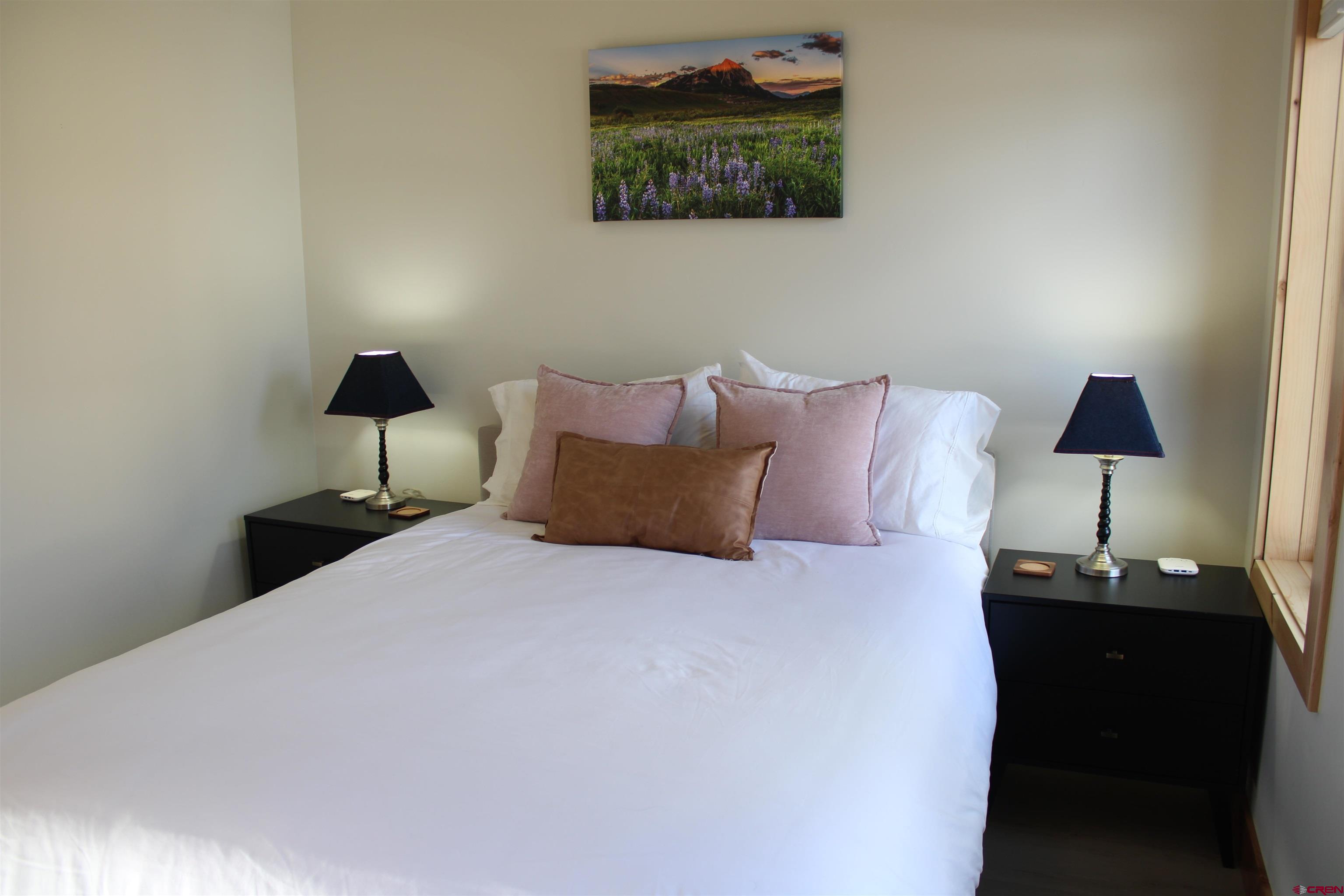 101 Elk Valley Road, Unit C Crested Butte, CO 81224 - Photo 15 of 41 a bedroom with a bed and a lamp